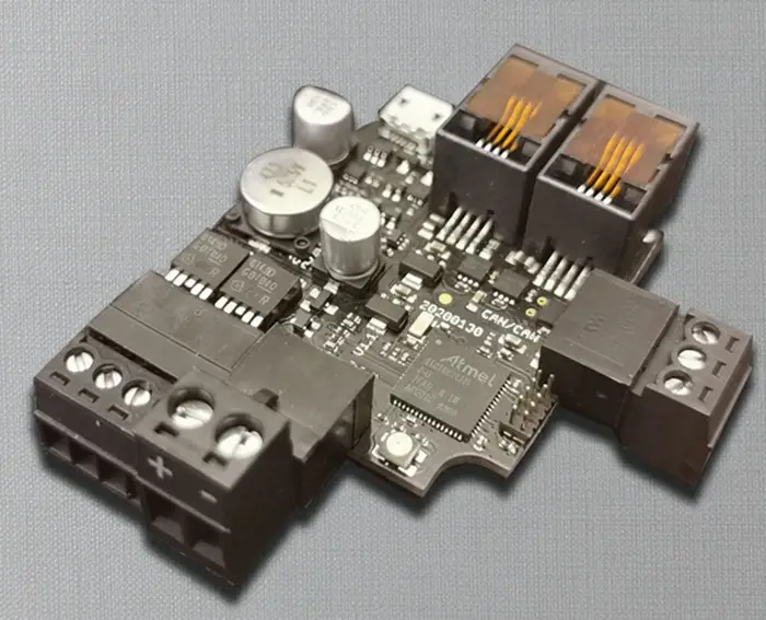 A high-resolution view of a custom electronic PCB by Digital Dividend, illustrating the CAN-Bus Reading Tool Executive Summary with various capacitors, connectors, and integrated circuits.